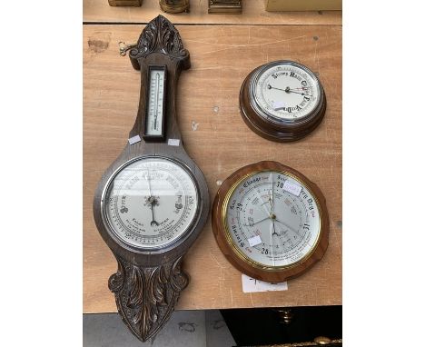 A carved oak wheel / banjo barometer; two circular barometers (3)