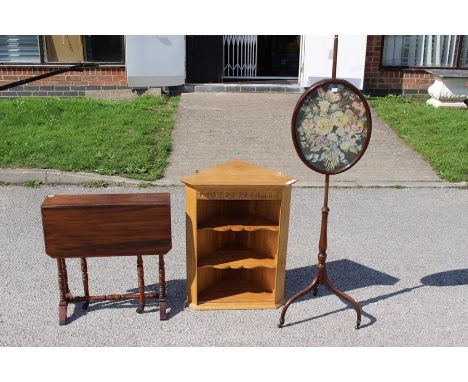 A 19th Century pole screen, the oval screen having a woolwork panel depicting flowers, an Edwardian mahogany Sutherland table