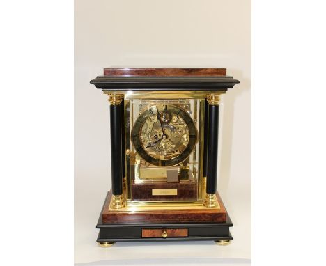 A Kieninger eight day bracket clock, of recent manufacture, burr walnut veneered case with open skeleton movement, four colum