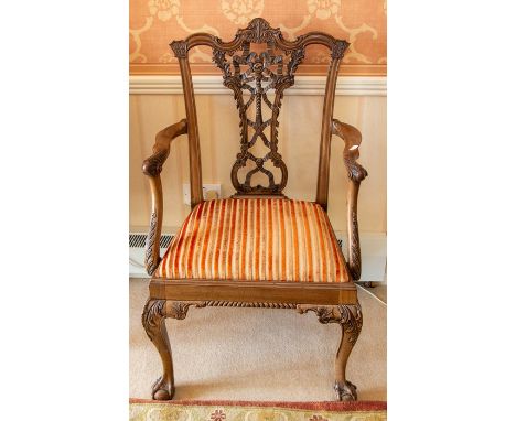 A Chippendale style open elbow armchair, 19th Century, the vase splat carved with complex ribbons, leaves and scrolls beneath