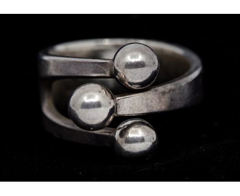 A Norwegian modernist silver 'Jester'  ring by Anna Greta Eker, comprising three bands to the front with ball terminals, size