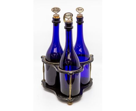 &nbsp;A set of three 19th Century Bristol blue glass decanters, of mallet shape, the white metal mounted cork stoppers with p