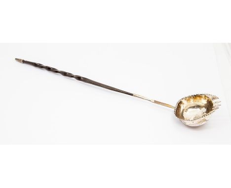 An 18th century Georgian 'toothed' toddy ladle, baleen twist handle, set with an Elizabeth I shilling dated 1601