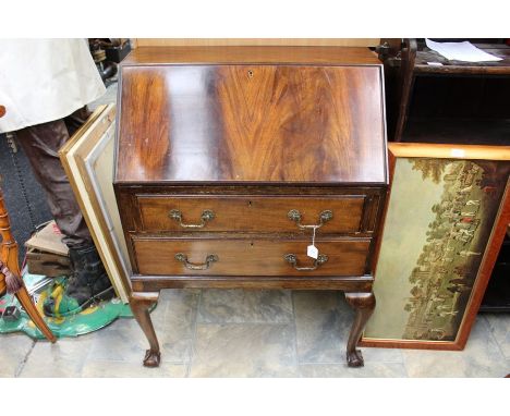 An early 20th Century mahogany bureau, the fall front enclosing a fitted interior, drawers below, raised on cabriole legs, to
