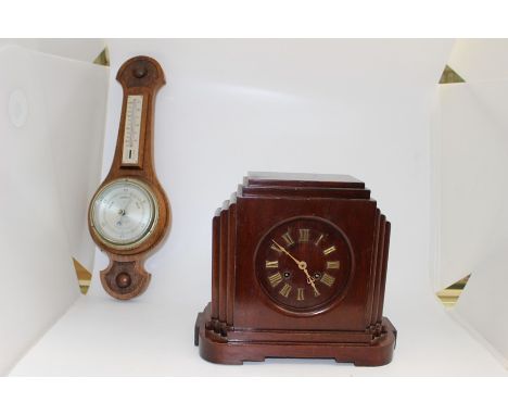 An Art Deco beech framed mantel clock, gilt Roman numerals together with a Victorian style oak framed barometer (crack to gla