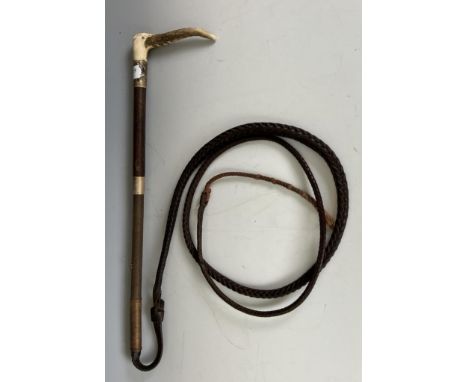 A horn handled whip, with silver mounts, makers label for Swaine & Adeney, London, a crop, and a wooden boot pull (3) 