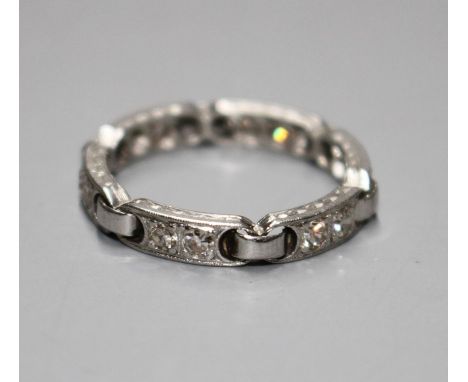 An unusual white metal (stamped Plat) and twelve stone diamond set eternity ring, with six 'chain' loop links, size N/O, gros