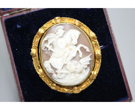 A Victorian yellow metal (tests as 15ct) mounted swivelling oval cameo brooch, carved with St George &amp; the Dragon, with l