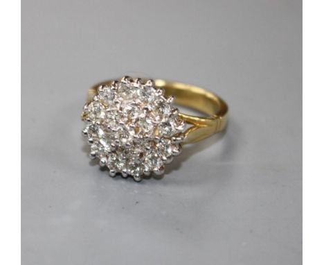 A modern 18ct gold and diamond cluster dress ring, size M, gross 7.8 grams.Condition- Two of the diamond each have a tiny nic