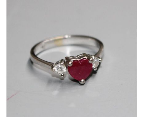 A modern 750 white metal, claw set heart shaped ruby and two round cut diamond set dress ring, size M/NCondition: Gross 2.6 g