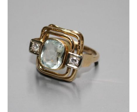 A 585 yellow metal, aquamarine and diamond set three stone dress ring, with pierced stepped setting, size KCondition: Gross w