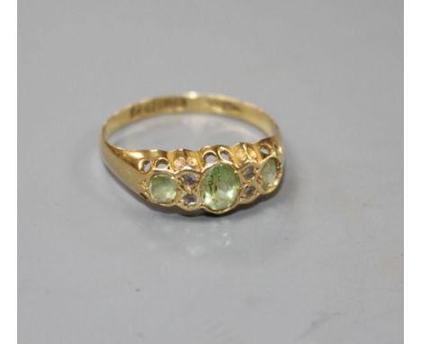 An early 20th century 18ct gold, green tourmaline and diamond chip set half hoop ring, size R, gross 2.2 grams.Condition- Dia