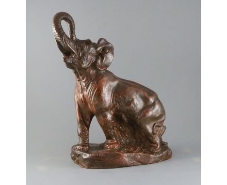 Thomas Francois Cartier (French, 1879-1943). A bronzed terracotta model of an elephant standing with raised trunk, signed, H.