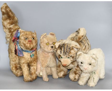 Four large vintage plush soft toy cats Condition:- 1950's white plush seated cat with pale blue / green ribbon and brass bell