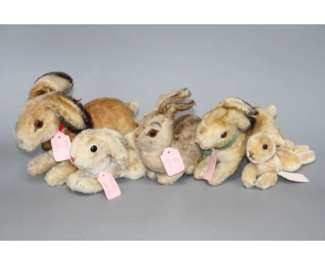 Two 1950s' Steiff 'Hoppy' rabbits, 23cm and 18cm, a 1940's 'Pummy' rabbit, 15cm, and two lying rabbits, 20cm and 15cm Conditi