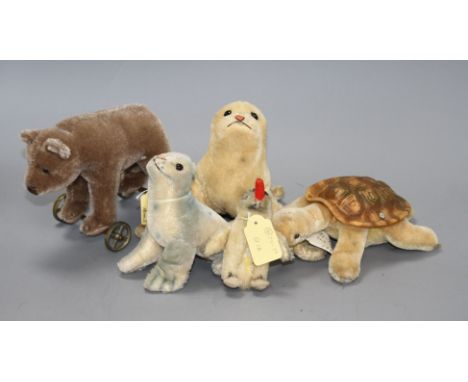 A 1960's Steiff 'Robby' sea lion, another similar larger sea lion, a penguin, a turtle and a more recent bear on wheels Condi