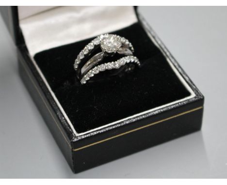 A modern 14kt white metal and triple band diamond dress ring, with two herringbone bands, each set with 13 graduated brillian