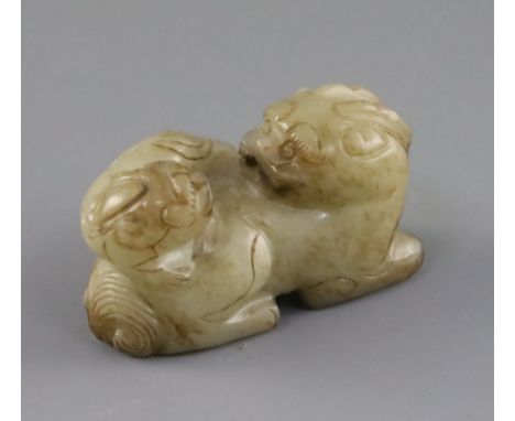 A Chinese pale celadon and brown jade group of a lion dog and cub, 18th / 19th century, length 6.3cm Condition: Natural inclu