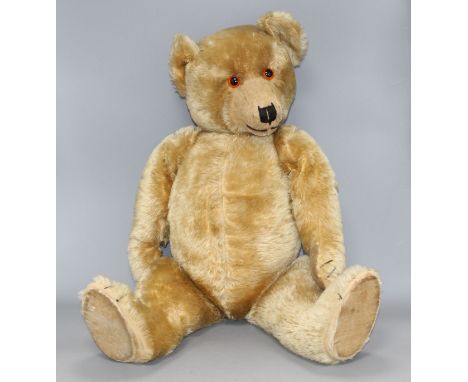 A Chiltern Hugmee 1930's bear, 25in., velvet pads, bald patch back of both legs and also back of neck