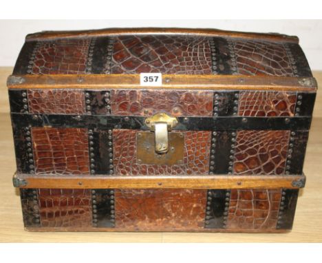 An early 20th century iron and wood bound crocodile covered miniature cabin trunk, with brass latch, length 46cm, height 31.5
