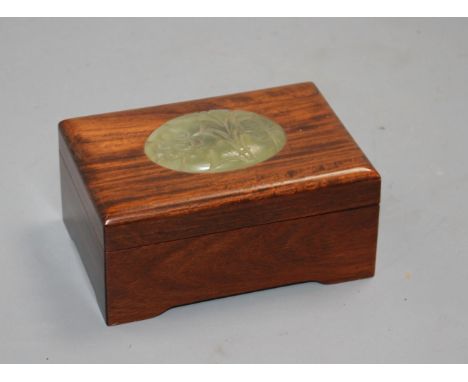 A Chinese hardwood box with inset bowenite jade panel, crack to wood on lid, otherwise in good condition 13cm