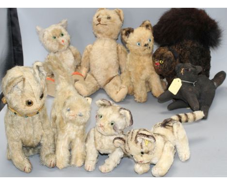 A collection of nine assorted vintage and later soft toy cats including Steiff Condition:- what was once blue seated cat with