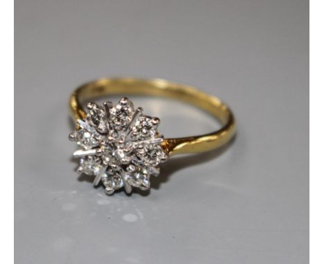 A modern 18ct and nine stone round cut diamond set flower head cluster ring, size P, gross 3.9 grams, Condition- Two of the d