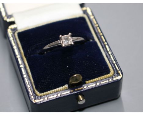 A modern 14k white metal and princess cut solitaire diamond ring, the stone weighing 0.25cts, with an estimated colour and cl