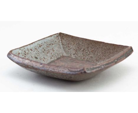 † JANET LEACH (1918-1997) for Leach Pottery; a small square stoneware dish partially covered in mottled dolomite glaze with t