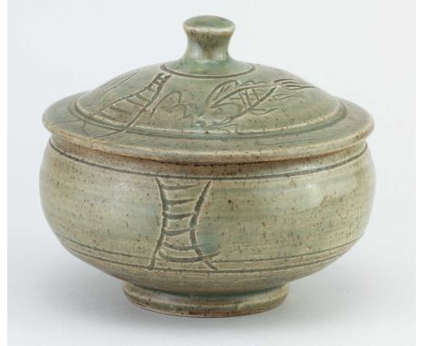 † JIM MALONE (born 1946); a stoneware pot and cover covered in green ash glaze with incised decoration, impressed JM mark, di