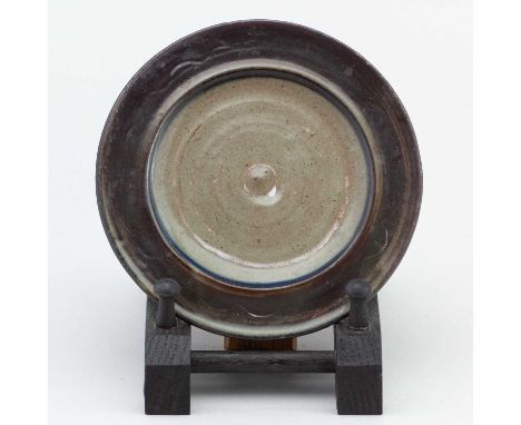 LADI KWALI (1925-1984) for Abuja Pottery; a small stoneware plate covered in iron and green ash glaze, impressed LK and potte