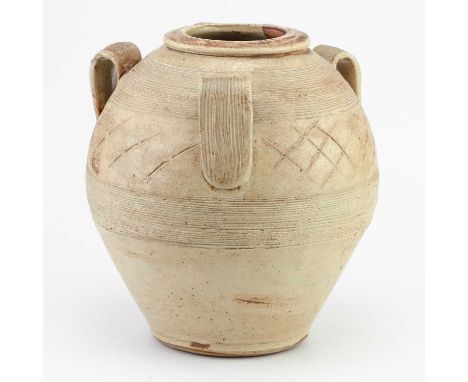 † BERNARD LEACH (1887-1979) for Leach Pottery; a salt glazed jar with three loop handles covered in pale mustard yellow glaze