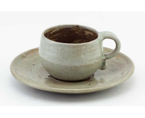 † KATHARINE PLEYDELL-BOUVERIE (1895-1985); a small stoneware cup and saucer covered in pale green ash glaze, impressed KPB ma