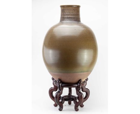 † DAVID LLOYD JONES (1928-1994); a very large bulbous stoneware bottle covered in olive green glaze, impressed mark, height 6