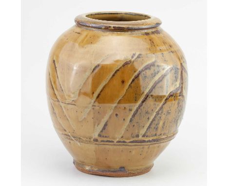 † MIKE DODD (born 1943); a globular stoneware vase covered in mustard river iron glaze with wax resist decoration, impressed 