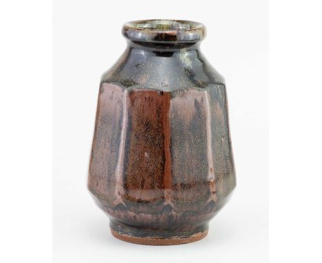 † MIKE DODD (born 1943); a faceted stoneware vase covered in tenmoku breaking to kaki glaze, impressed MJD mark (glaze filled