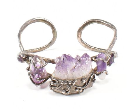 A 925 silver and Amethyst cuff bangle. The bracelet stamped 925. Weight 43.4g. Measures 7.5cm x 7cm.&nbsp;All weights, measur