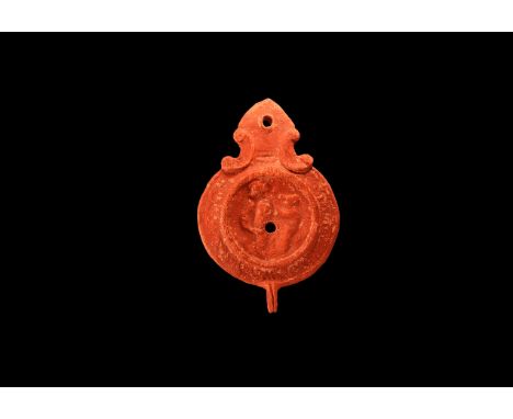 An undated archaistic ceramic redware oil lamp in 1st-2nd century AD style, with pointed nozzle, pekta shaped volutes to the 
