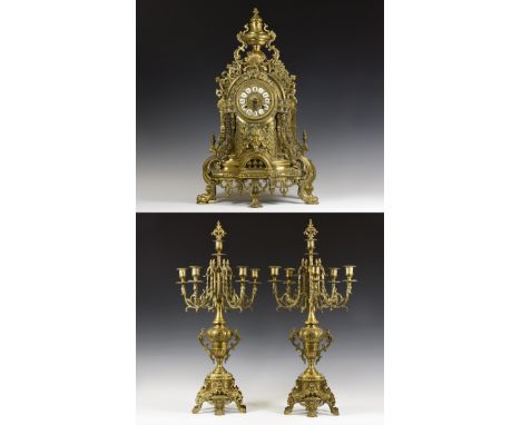 20th century AD. A large and imposing gilt mantle garniture comprising an ornate chiming clock with black on white enamelled 