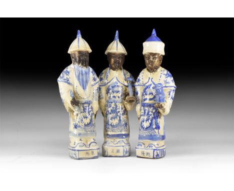 20th century AD. A group of the three ceramic statuettes of emperors wearing a conical hat, pig-tail down the back; wearing l