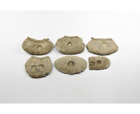 12th-15th century AD. A group of six lead palm-guards for needlework, each with a recess to one face.   1.2 kg, 62-95mm (2 1/