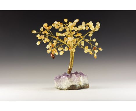 A display tree of yellow wire trunk and branches tipped with tumble-polished yellow citrine crystals, mounted on a section of