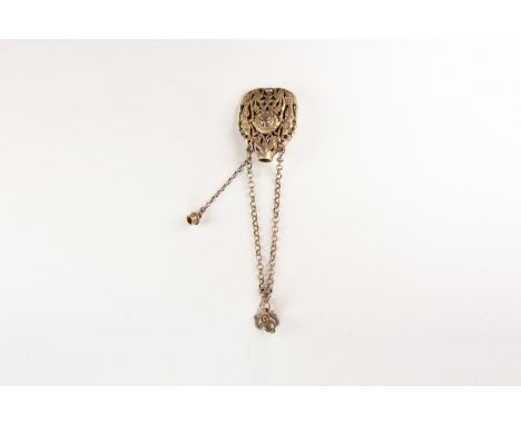 An undated archaistic white metal chain bracelet with facing-mask closure, openwork bifacial frame pendant with figures, foli