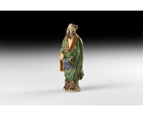 20th century AD. A hollow-formed glazed ceramic figure in loose robe holding a plumed fan in his right hand.   131 grams, 12.