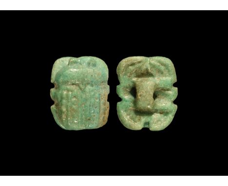 Saite Period, 624-525 BC. A green glazed composition scarab with ribbed carapace, loop to the underside for attachment to ban