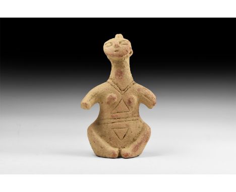 An undated archaistic ceramic idol with incised lines to the body, discoid face with spike to the rear.   600 grams, 18cm (7"