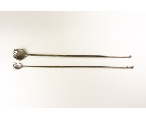 19th century AD. A pair of iron back scratchers with long rod shaoed handles ending in a hand with fingers bent, collar to th
