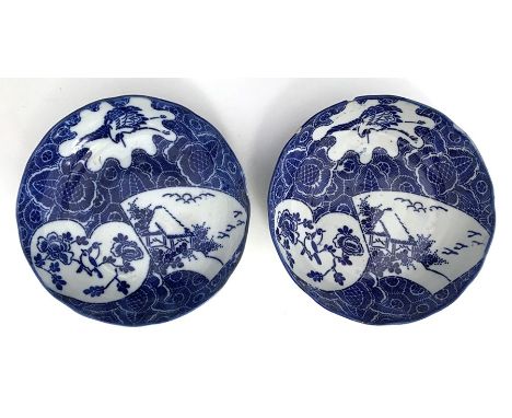 A pair of Kangxi (1662-1722) bowls in blue and white with lobed rim decorated with Prunus, song birds, stork, etc, each 15cmD