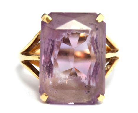 A 9ct. Gold Amethyst Dress Ring with a large rectangular pale violet stone , measuring 12x19mm approximately. Gross weight 6.