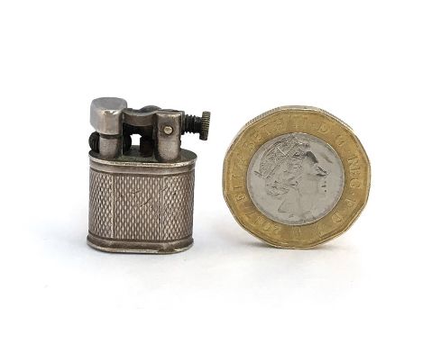 A Dunhill `Baby Sylph` Miniature Cigarette Lighter, the silver plated body with lift-arm and hatched body, link to the base, 